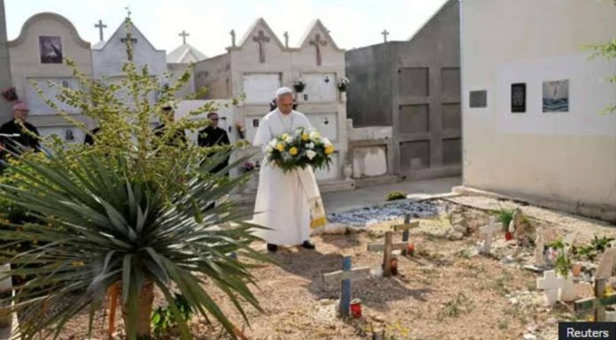 Pope_compressed_resized Holding flowers at a cemetery in the island of Lampedusa in Italy, Pope Leo XIV prays at the graves of migrants who had died while making the journey from Africa to Italy. REUTERS
