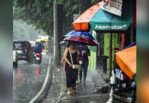 Pedestrians are caught in a downpour in Quezon City. Super Typhoon Inday entered the Philippine Area of Responsibility at 3 a.m. on Wednesday. Metro Manila is expected to bear the brunt of its impact. PNA