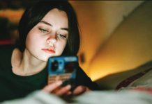 Midnight social media curfew proposed for UK teens aged 16, 17 A teenage girl looks at her phone at nighttime in low lighting with the glow of a lamp. Older teenagers in the United Kingdom will face an overnight social media curfew. GETTY IMAGES
