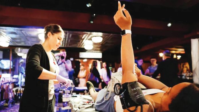 US A woman raises her arm following a blood donation in the United States. A blood supply shortage in the US has reached a “crisis” level, according to the American Red Cross. GETTY IMAGES