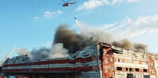 A firefighting helicopter drops water over the site of a Russian missile strike, amid Russia's attack on Ukraine, in Kyiv region. The latest Russian strikes hit both residential and non-residential buildings. REUTERS