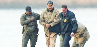 Former president Nicolas Maduro of Venezuela is seen in handcuffs after landing at a Manhattan helipad, escorted by heavily armed Federal agents as they make their way into an armored car en route to a Federal courthouse in New York. GETTY IMAGES