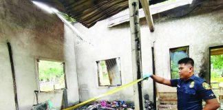 A fire officer from the Bureau of Fire Protection-Anilao inspects the gutted house in Barangay Dangulaan, Anilao, Iloilo. The blaze claimed the life of an 84-year-old woman on Wednesday night, July 22, 2026. PHOTO COURTESY OF BFP-ANILAO