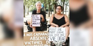 French protesters in wheelchairs hold up signs reading “I am not a reason to die” and “Before a dignified death, I want to see a dignified life” during a protest against the assisted dying bill. EPA