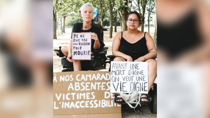 French protesters in wheelchairs hold up signs reading “I am not a reason to die” and “Before a dignified death, I want to see a dignified life” during a protest against the assisted dying bill. EPA