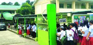 Students of Barotac Nuevo National Comprehensive High School line up as security personnel conduct thorough bag inspections at the school gate before the start of afternoon classes on Wednesday, July 1. This heightened security measure was implemented after a Grade 10 student was found in possession of a firearm after his class adviser inspected his bag on Tuesday. PN PHOTO
