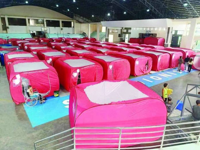 evac_center_compressed_resized Iloilo Provincial Disaster Risk Reduction and Management Office head Cornelio Salinas says disaster preparedness must extend to the barangay level. “This will enable faster evacuation, earlier prepositioning of relief supplies and emergency equipment, and quicker deployment of responders,” he explains. Left photo shows tents at the municipal evacuation center of San Dionisio, Iloilo where residents from 18 flood-prone areas sought shelter during the November 2025 onslaught of Typhoon “Tino”. PHOTO COURTESY OF ORLAN OLVIDO / DYRI RMN ILOILO