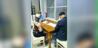 Alias “Jerry” (left), a former police officer facing murder charges, surrenders to Police Regional Office 6 acting director Brigadier General Randulf T. Tuaño at around 12:45 a.m. on July 5, 2026. PRO-6 PHOTO