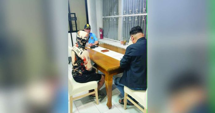 ex police_compressed_superimposed Alias “Jerry” (left), a former police officer facing murder charges, surrenders to Police Regional Office 6 acting director Brigadier General Randulf T. Tuaño at around 12:45 a.m. on July 5, 2026. PRO-6 PHOTO