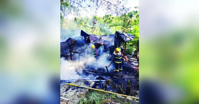 hamtic fire_superimposed Personnel from the Bureau of Fire Protection-Hamtic work to extinguish a residential fire in Barangay Igbical, Hamtic, Antique, on Saturday morning, July 18, 2026. PHOTO COURTESY OF GONZAGA VLOG