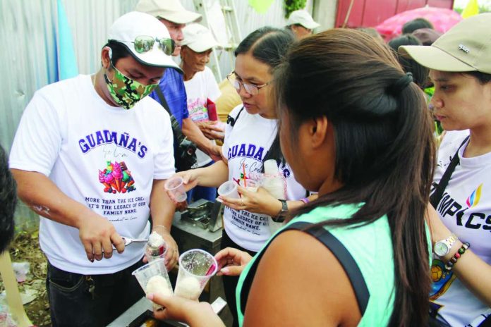 ime_Pavia_sorbete_(1)_copy_compressed_resized SWEET LEGACY. Members of Pavia, Iloilo’s pioneering Guadaña family serve their signature sorbete to Pavianhons during an “Ice Cream Festival” just this May, showcasing the century-old tradition that helped earn the municipality – particularly Barangay Anilao – the title of “Sorbete Capital of Iloilo”. AJ PALCULLO/PN