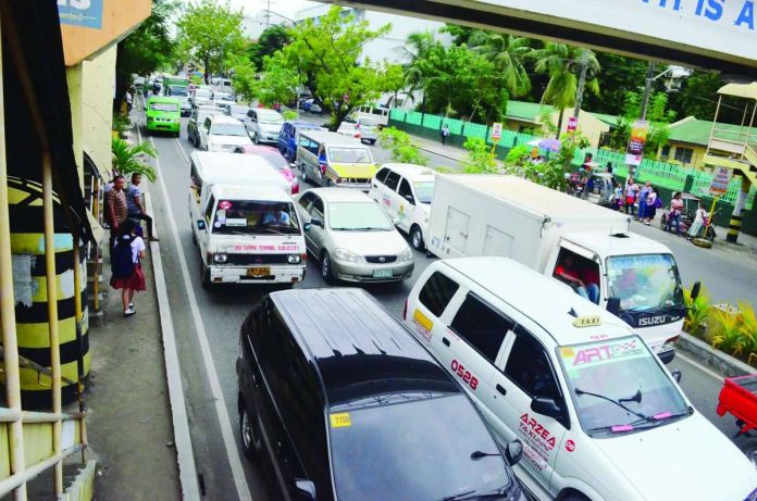 mai_traffic_violators_copy_compressed_resized TRAFFIC SQUEEZE. Vehicles crowd a busy General Luna Street in Iloilo City as the city government intensifies traffic enforcement and road-clearing operations. Authorities apprehended 23,521 traffic violators and conducted 962 operations during the first year of Mayor Raisa Treñas’ administration. PN