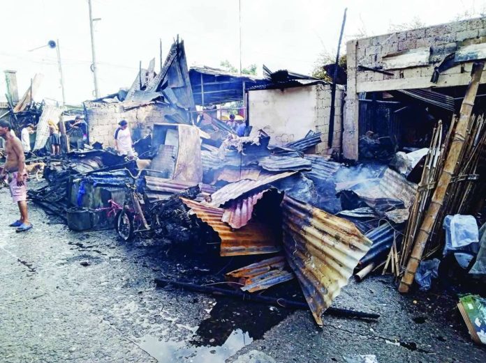 Residents inspect what remains of their homes and properties in Barangay Muelle Loney, City Proper district after a fire broke out early Monday morning, July 25, 2026. PHOTO COURTESY OF DYRP LIFE RADIO ILOILO