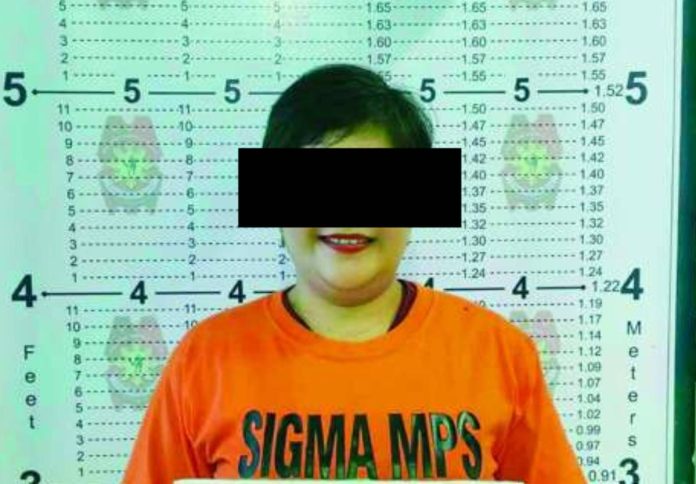 neljoy broadcaster_compressed_superimposed Capiz broadcaster India O. Lavapiez poses for a police booking photograph following the service of a March 2026 arrest warrant issued by the Regional Trial Court, Branch 28, National Capital Judicial Region for cyber libel. Lavapiez is again facing legal trouble after the Office of the Provincial Prosecutor of Capiz found probable cause to charge her with cyber libel over remarks aired on her radio program.