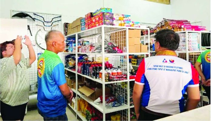 Senior Labor and Employment Officer Danny Espinosa of the Department of Labor and Employment - Region 6, together with officials of the Cabatuan, Iloilo municipal government, inspects the spare parts, equipment and other livelihood inputs turned over under DOLE’s P1.5-million Spare Parts Retailing and Vulcanizing Shop Project for members of the Cabatuan Federation of Transport Association (CAFTA) and the Local Tricycle Operators and Drivers Association (TODA). The livelihood initiative aims to provide transport workers with a sustainable source of income through community-based enterprise. DOLE-6