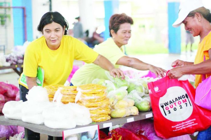neljoy_Walang_Gutom_copy_compressed_resized FOOD FOR FAMILIES, LIVELIHOODS FOR COMMUNITIES. Beneficiaries of the Department of Social Welfare and Development's Walang Gutom Program redeem food items from accredited Sustainable Livelihood Program Associations (SLPAs) in Iloilo. The initiative generated more than ₱20.8 million in gross sales during the first half of 2026, providing income opportunities for local livelihood groups while helping strengthen food security for nearly 7,000 program beneficiaries. DSWD-6