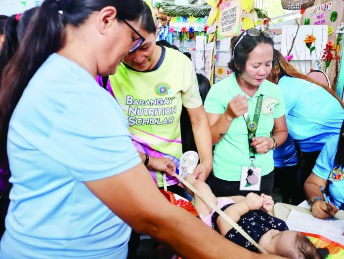 neljoy_health_caravan_(2)_copy_compressed_resized Health workers conduct nutrition assessment and other primary healthcare services for children while indigenous families and residents participate in the PuroKalusugan health caravan in Barangay Buntatala, Jaro, Iloilo City. Organized by the Department of Health in partnership with the Iloilo City Health Office and local stakeholders, the initiative brought free medical consultations, immunization, oral healthcare, health education, and other essential services closer to indigenous peoples and underserved communities. DOH-6