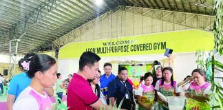 Participants and guests view an exhibit showcasing locally grown fruits, vegetables and other nutritious food products during the opening of the 52nd Regional Nutrition Month celebration at the Leon Multi-Purpose Covered Gym in Leon, Iloilo. NNC REGION 6