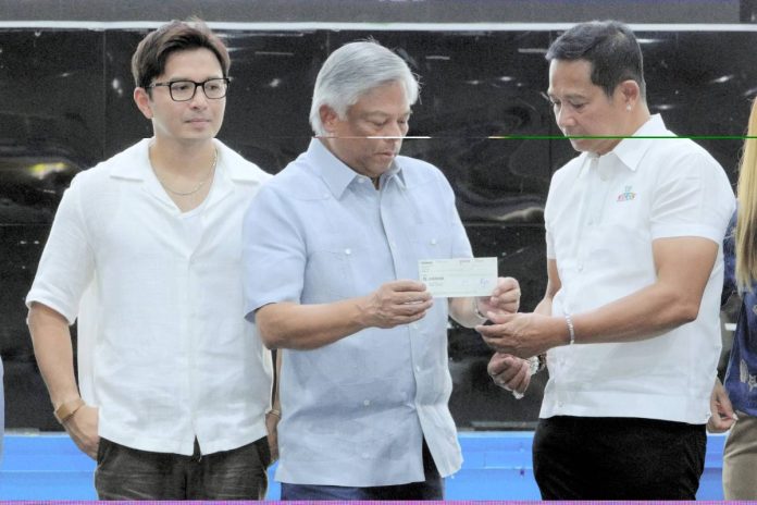pagcor1 PAGCOR Chairman and CEO Alejandro H. Tengco (center) turns over a P10 million check to Bulacan Governor Daniel Fernando (right) and Vice Governor Alexis Castro for the first tranche of the Ayudang Hatid ay Tagumpay Scholarship Program at the Bulacan Capitol Gymnasium in Malolos City on July 6.