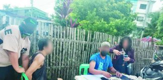 Officers of the Pavia Municipal Police Station arrested alias “Nil” (second from left), a high-value drug suspect, and confiscated around P408,000 worth of suspected shabu on July 13 during a buy-bust operation in Barangay Cabugao Sur, Pavia, Iloilo. IPPO PHOTO