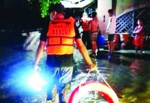 Members of the Rapid Drainage Response Team of the Bacolod City Engineer's Office cleared clogged drainage along a flooded street in Bacolod City on Tuesday, July 14, following heavy overnight rains that inundated several barangays and displaced 15 families. Authorities continue assessing flood-affected areas while implementing measures to improve the city's drainage system and mitigate future flooding. BCCO PHOTO