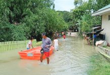 Residents wade through floodwaters in Barangay Jebioc, Pototan, Iloilo on Sunday, July 12, 2026. Jebioc is among the 31 barangays in the municipality hit by widespread flooding brought on by continuous southwest monsoon (habagat) rains. POTOTAN ILOILO NEWS SPOTTED/FACEBOOK PHOTOO PHOTO