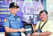 Iloilo City Police Office director Colonel Wilbert B. Parilla (left) presents a token to MORE Electric and Power Corporation president and chief executive officer Roel Z. Castro during the culmination ceremony of the 31st Police Community Relations Month on July 27, 2026. Castro praises the ICPO for a significant drop in local crime rates while highlighting the effective partnership between law enforcement and the power distribution utility.