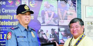 Iloilo City Police Office director Colonel Wilbert B. Parilla (left) presents a token to MORE Electric and Power Corporation president and chief executive officer Roel Z. Castro during the culmination ceremony of the 31st Police Community Relations Month on July 27, 2026. Castro praises the ICPO for a significant drop in local crime rates while highlighting the effective partnership between law enforcement and the power distribution utility.