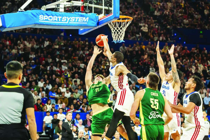 sports_Gilas_compressed_resized Gilas Pilipinas forward Michael Phillips contests a shot by an Australian Boomers player during their FIBA Basketball World Cup 2027 Asian Qualifiers game at RAC Arena in Perth, Australia.