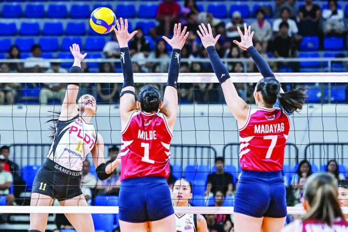PLDT High Speed Hitters’ Kim Kianna Dy fires an attack over the defense of Choco Mucho Flying Titans' Isa Molde during their PVL On Tour match at the Chavit Coliseum in Vigan City, where the defending champions opened their title defense with a four-set victory. PVL PHOTO