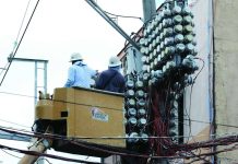 Distribution utility personnel inspect the power transformer and electric meters on a concrete post in Barangay Tatalon in Quezon City. President Ferdinand R. Marcos Jr., during his fifth State of the Nation Address on July 27, called for amendments to the Electric Power Industry Reform Act to prohibit charging systems loss to consumers. PNA PHOTO BY JOEY O. RAZON
