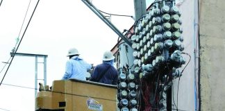 Distribution utility personnel inspect the power transformer and electric meters on a concrete post in Barangay Tatalon in Quezon City. President Ferdinand R. Marcos Jr., during his fifth State of the Nation Address on July 27, called for amendments to the Electric Power Industry Reform Act to prohibit charging systems loss to consumers. PNA PHOTO BY JOEY O. RAZON