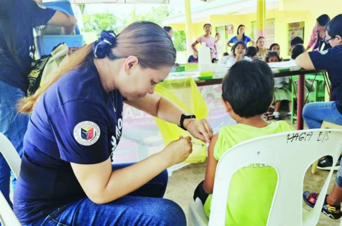 vaccination_compressed Over 400,000 children across Western Visayas are targeted for protection in the Measles-Rubella Supplemental Immunization Activity running from Aug. 10 to 28, 2026. Department of the Interior and Local Government Region 6 director Juan Jovian Ingeniero assured the public that the vaccines are safe and free and available at local health centers and designated areas by local governments. Right photo shows learners from Paga Elementary School in San Enrique, Iloilo receiving immunization against measles, rubella, tetanus, diphtheria, and Human Papillomavirus during a "Bakuna Eskwela" campaign. SAN ENRIQUE PRIMARY HEALTH CARE FACILITY PHOTO