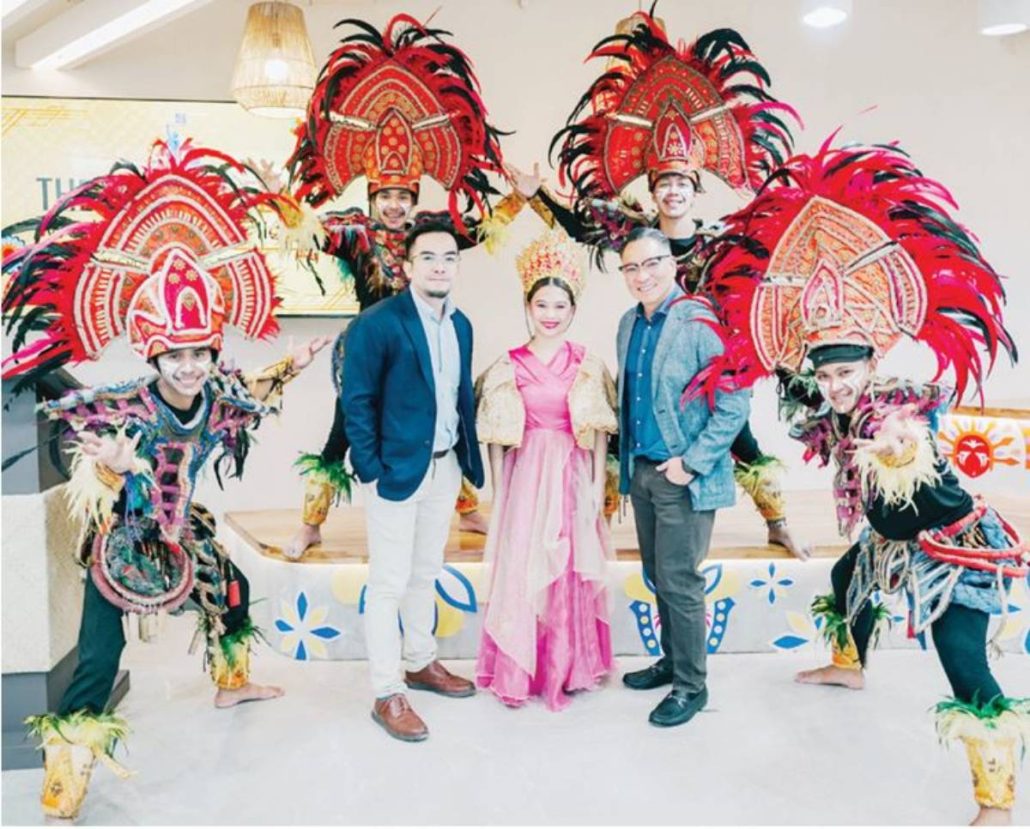 (L-R) Mr. Elton John N. Peralta, Senior Director and Head of work.able, and Mr. Jericho P. Go, SVP and Business Unit General Manager and work.able landlord, pose with the Dinagyang dancers during the ceremonial opening of work.able Iloilo.