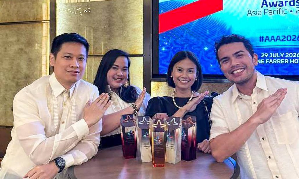 Palawan Group representatives strike the brand’s signature “Happy to Serve You” pose while celebrating the company’s wins.