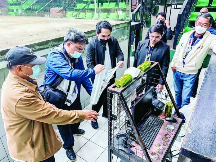 BIR_cracks_down_compressed_resized Bureau of Internal Revenue (BIR) personnel inspect and document betting machines and other equipment during a simultaneous enforcement operation at a cockpit arena on Aug. 8, 2026. BIR said 297 betting machines, computerized betting units, servers, and other devices without the required Permit to Use and not appearing in BIR records were sealed or confiscated, as warranted under existing rules. PHOTO COURTESY OF BIR