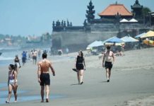 Bali jails Swiss tourist for insulting sacred Day of Silence Tourists walk on a beach in Bali, where its usually bustling beaches turn empty during Nyepi, an annual Hindu holiday. AFP VIA GETTY IMAGES