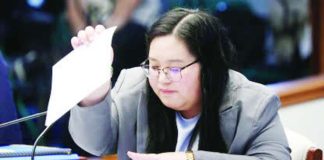 State auditor Xylene Mae Del Campo of the Commission on Audit pores through the acknowledgment receipts submitted by the Office of the Vice President as she testifies before the Senate impeachment court on the office’s confidential fund expenditures.