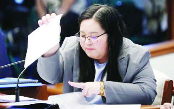 COA_witness_copy_compressed_resized State auditor Xylene Mae Del Campo of the Commission on Audit pores through the acknowledgment receipts submitted by the Office of the Vice President as she testifies before the Senate impeachment court on the office’s confidential fund expenditures.