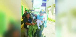 A police officer carried an unconscious student while a teacher assisted in rushing the learner to safety after around 20 students of Jamindan National High School in Jamindan, Capiz experienced dizziness and other symptoms during a suspected mass hysteria incident on August 4. Classes were suspended as authorities investigated the incident. JAMINDAN PNP PHOTO
