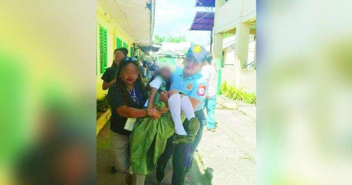 Capiz mass hysteria copy_superimposed A police officer carried an unconscious student while a teacher assisted in rushing the learner to safety after around 20 students of Jamindan National High School in Jamindan, Capiz experienced dizziness and other symptoms during a suspected mass hysteria incident on August 4. Classes were suspended as authorities investigated the incident. JAMINDAN PNP PHOTO