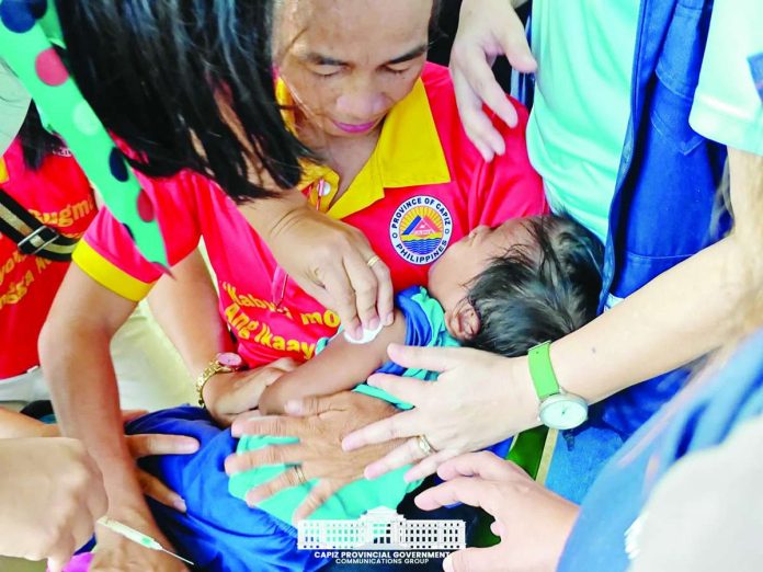 Capiz_vaccine_compressed_resized Children in Dumarao, Capiz received free measles and rubella vaccinations during the provincial government’s Supplemental Immunization Activity on August 14, 2026. CAPIZ PROV’L GOV’T COMMUNICATIONS GROUP PHOTO