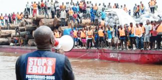 The Yingfeng 2 boat was intercepted on the Congo River before it could reach Kinshasa. A man with a megaphone gives instructions. REUTERS