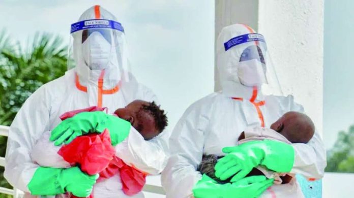 Congo_copy_compressed_resized Two health workers in hazard suits each hold a young baby in the Democratic Republic of Congo. Ebola, which spreads through contact with bodily fluids, has killed 15,000 people across Africa over the last 50 years. REUTERS