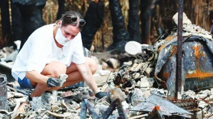 France A woman picks through the burned remains of her home in Le Porge, France after it was destroyed in a wildfire. REUTERS