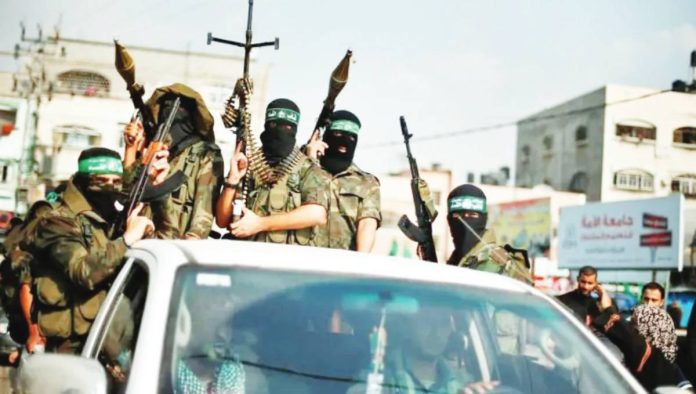 Hamas militants celebrate what they say is a victory over Israel after an eight-day conflict during a rally in the northern Gaza Strip November 22, 2012. Hamas weapons would be handed over to the Board of Peace, United States President Donald Trump said. REUTERS
