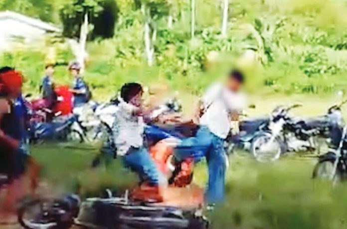 A screenshot from a video shows the 16-year-old Grade 11 student being allegedly assaulted by a group of men outside a high school in La Castellana, Negros Occidental on July 29. Police said the suspects, who were reportedly not students of the school, allegedly mistook the victim for another person linked to a conflict between two groups. GMA REGIONAL TV PHOTO