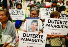 Relatives of war on drugs victims hold placards calling for justice. Former president Rodrigo Duterte faces a crimes against humanity charge at the International Criminal Court over the drug war killings. REUTERS