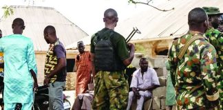 Members of Nigeria’s army interact with residents following the attack in Woro, Kwara State. Following the February attack, community leaders think more than 160 people were abducted. AFP VIA GETTY IMAGES