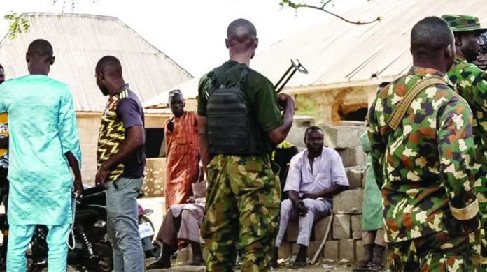 Nigeria_compressed_resized Members of Nigeria’s army interact with residents following the attack in Woro, Kwara State. Following the February attack, community leaders think more than 160 people were abducted. AFP VIA GETTY IMAGES